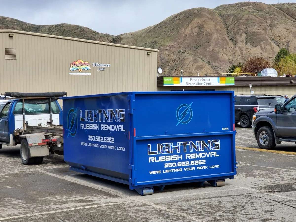 Blue Lightning Rubbish Removal bin dropped in a parking lot at Brocklehurst Recreation Centre, Kamloops